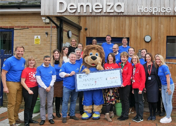 Demelza’s staff receive a cheque from Team RBC