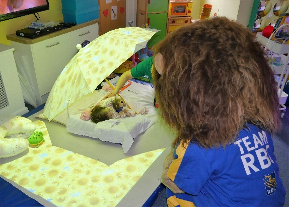 Leo the Lion watches over 2 year old Demelza resident, Melissa