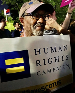 Photo of Helima's dad holding a Human Rights Campaign sign