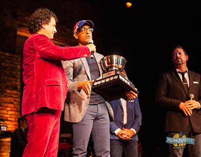 Photo of Ram Amarnath receiving the award 'Funniest Amateur' for his amazing performance