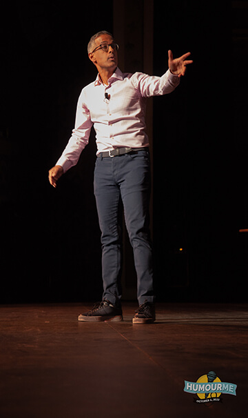 Photo of Ram Amarnath on stage for the charity comedy event