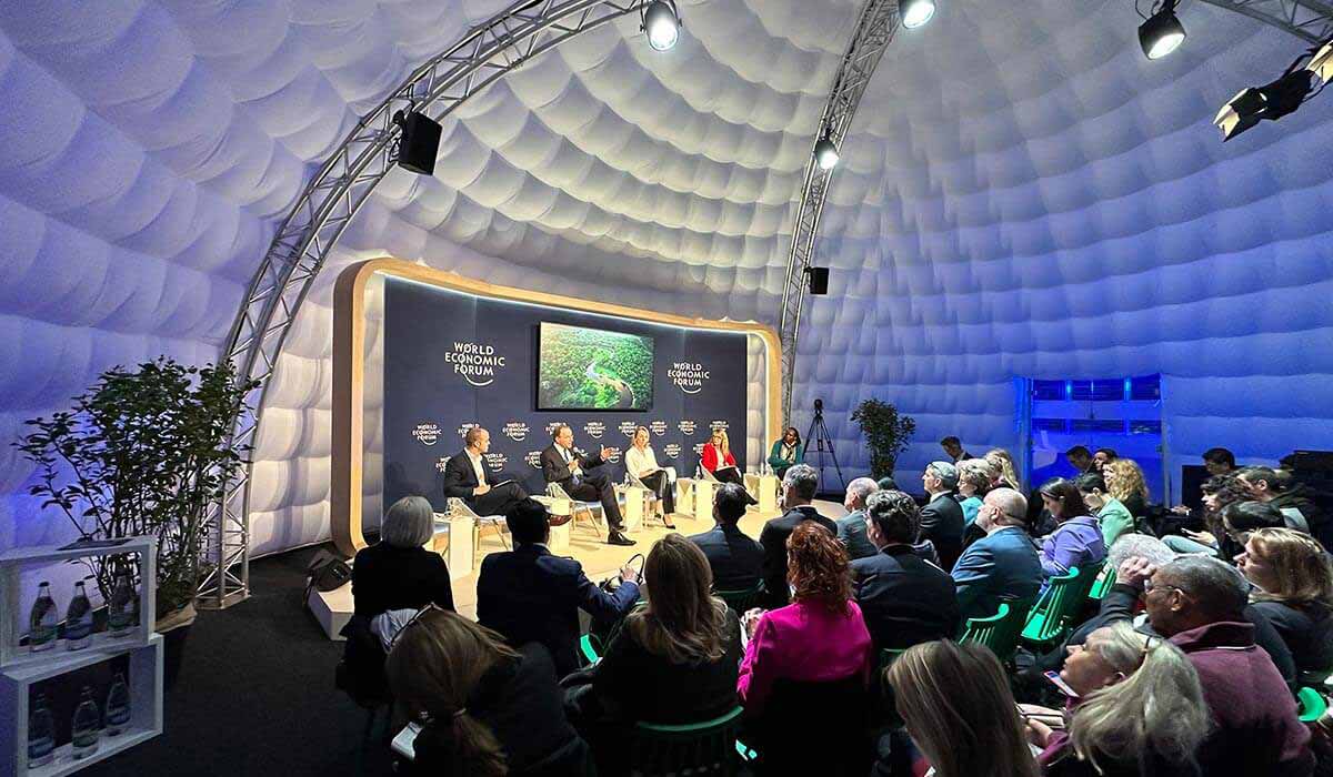 Inside a dome, a panel is being held