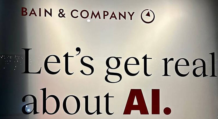 Image of Davos event -  Bain & Company - Let's get real about AI text closeup