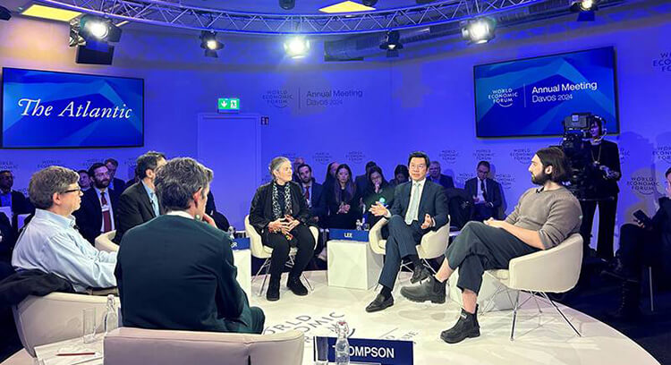 Image of Davos event - small group discussion presentation, The Atlantic with people sitting on chairs in a circle