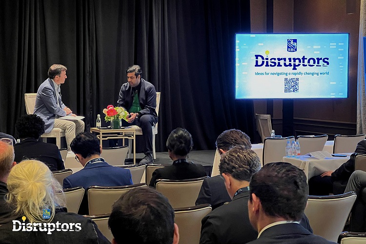 John Stackhouse and Sachin Dev Dugal on stage with an audience image