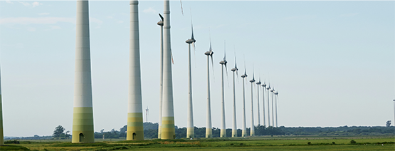 Hydro wire tower within a grass field and blue sky image