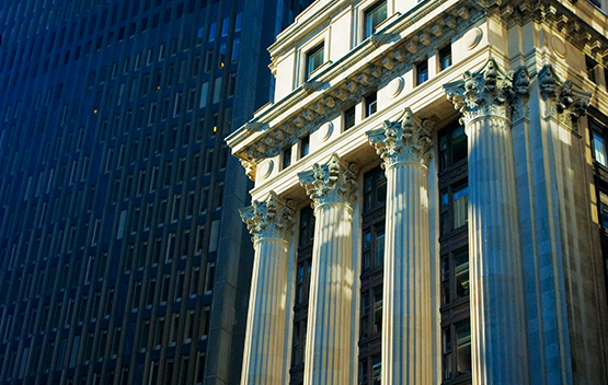 Old bulding with columns next to modern tower at night image