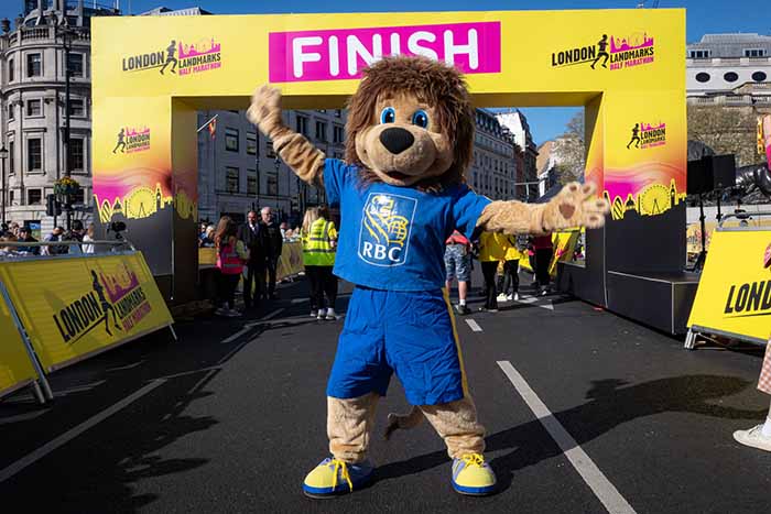 Image of Leo the Lion in front of the finish line