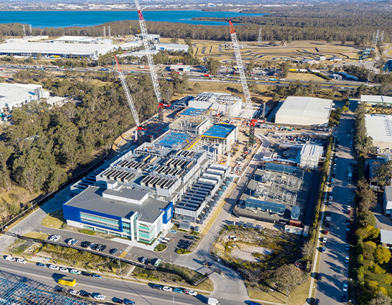 Image of battery storage containers in a lot with a sunset