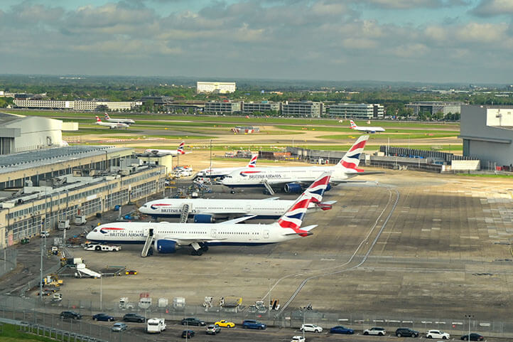 Airport building with planes lined up near loading areas image