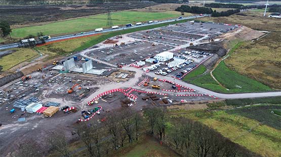 Image of view of facility from above showing buildings, parking lot, fields